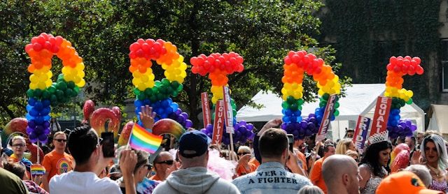 A Pride sign carried by people at a pride parade. 